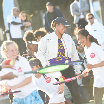 Naomi playing tennis with girls