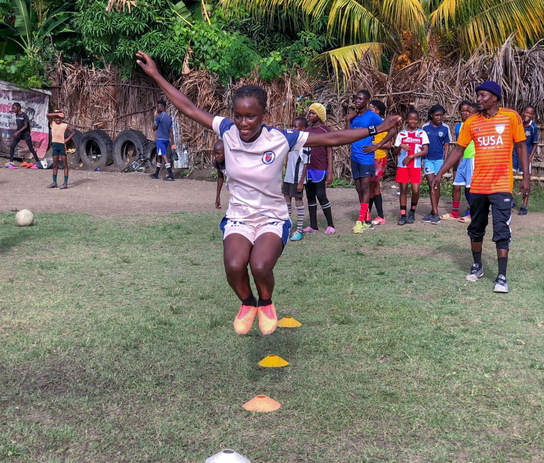 Girl jumping as part of soccer drill
