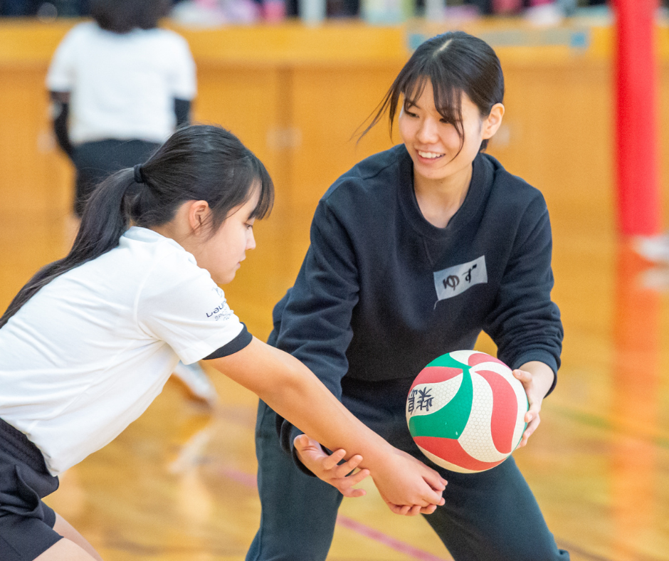 Coach teaching student how to bump a volleyball