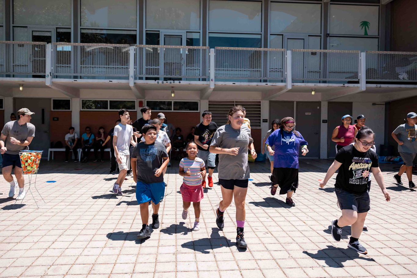 Coach leads warm-up activity with kids