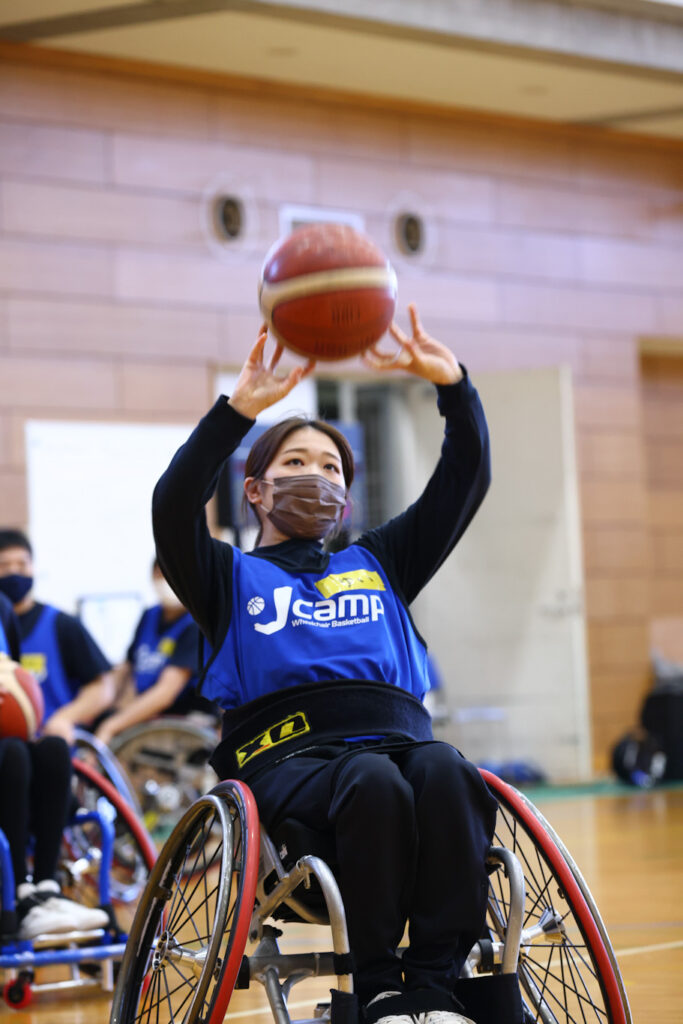 Girl in wheelchair shoots a basketball