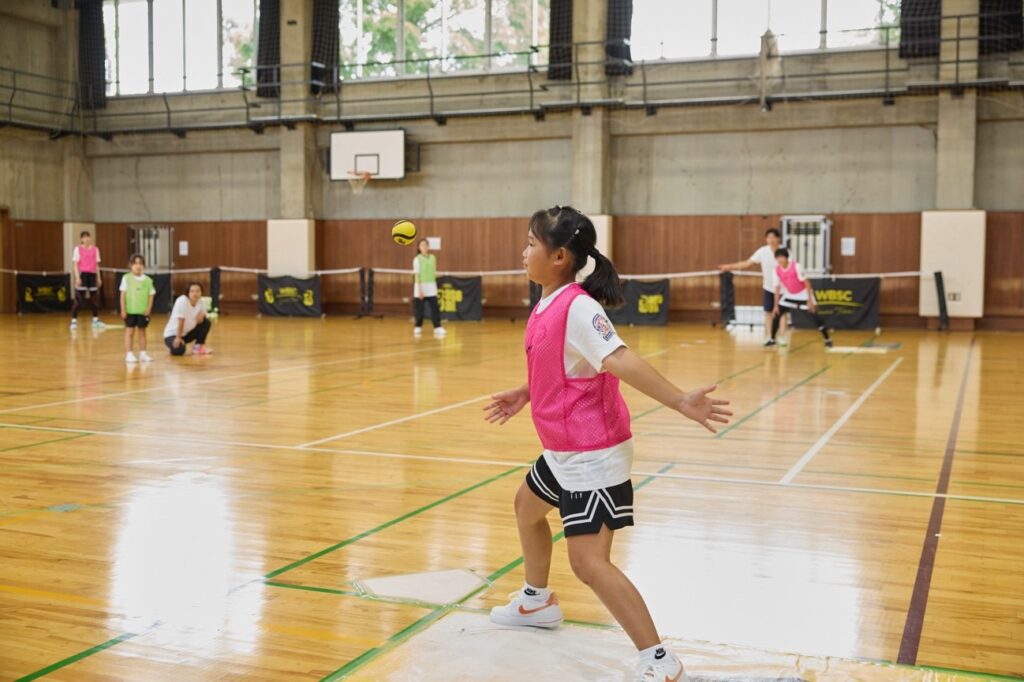 Girl does a sports drill in baseball5