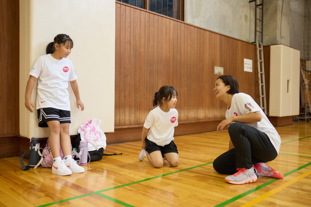 Coach speaking with girls