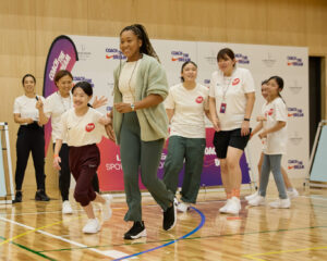 Naomi Osaka partners with a girl for an activity