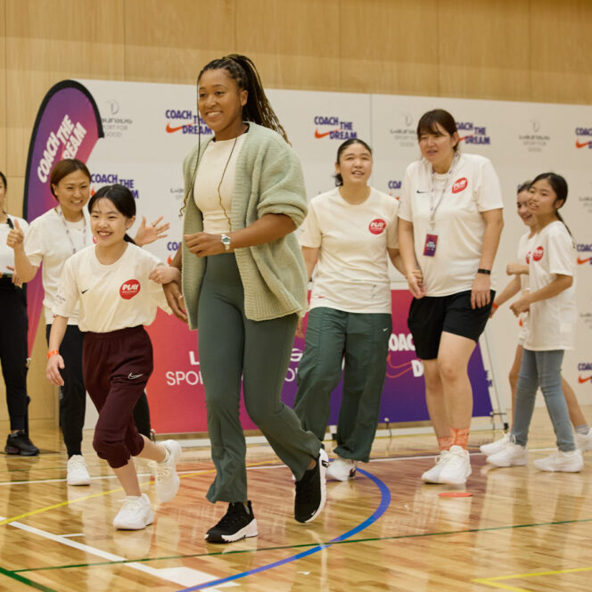 Naomi Osaka partners with a girl for an activity