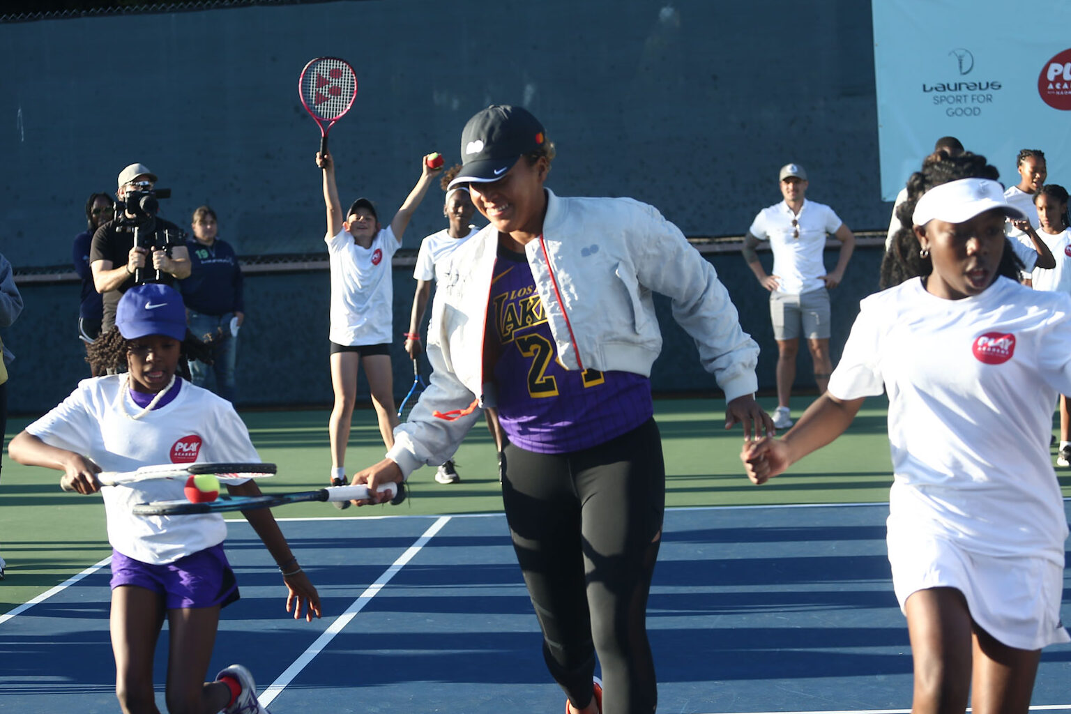 Girls racing with tennis rackets