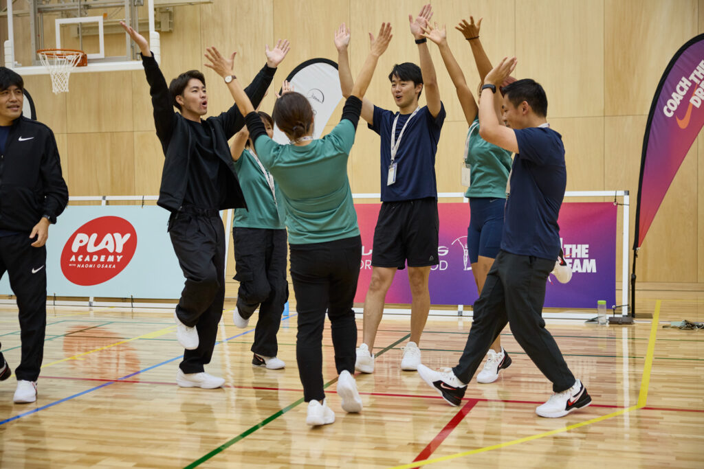 Coaches celebrating in a huddle