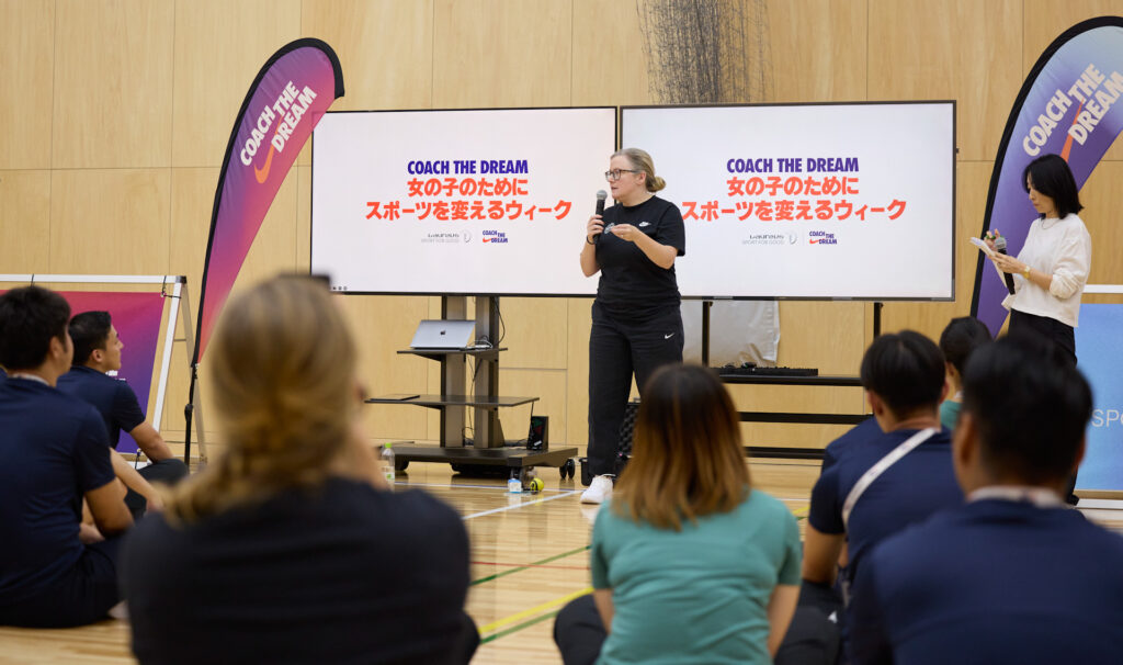 Woman speaks to a group during a training