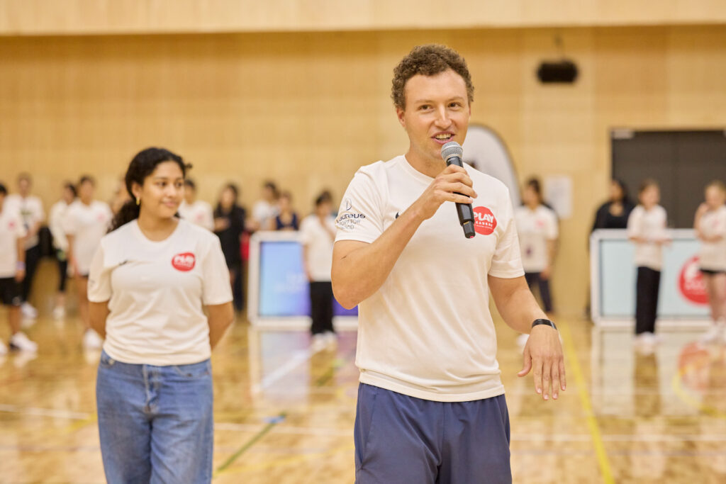 A man and woman explain the warm-up activity to the group